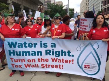 Members of the National Nurses United march in Detroit July 18, 2014.